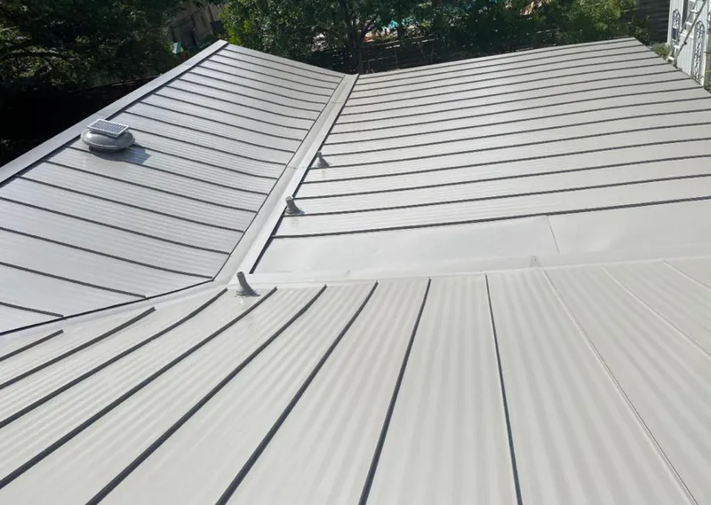 Solar attic fan installed on a metal roof for Roof Ventilation in Starkville